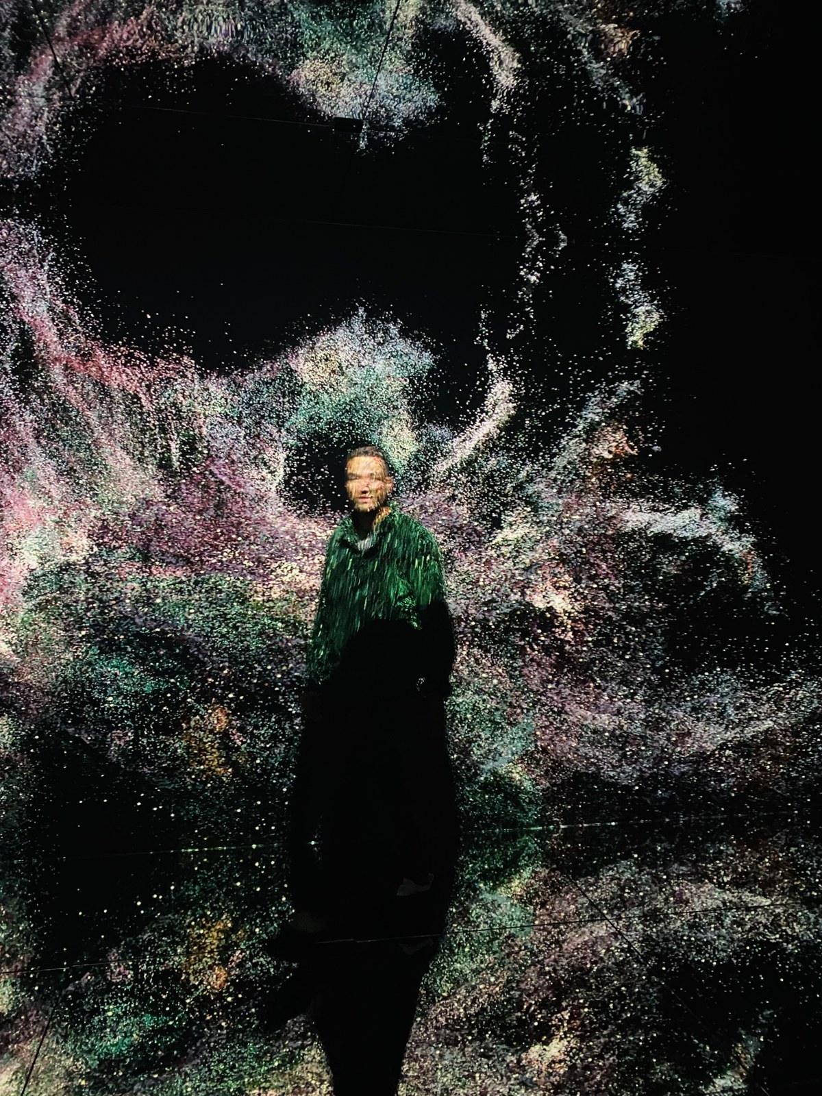 Kofi standing inside the particle projection at NXT Museum, Amsterdam